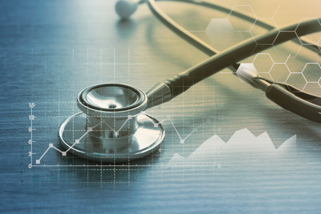 stethoscope on table with hospital data superimposed on top of it